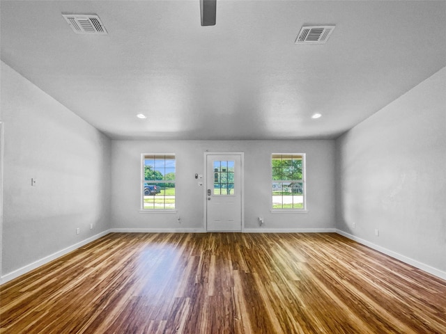 316 W 3rd Ter, Springtown, TX 76082 - unfurnished living room with a ceiling fan, visible vents, wood finished floors, and baseboards