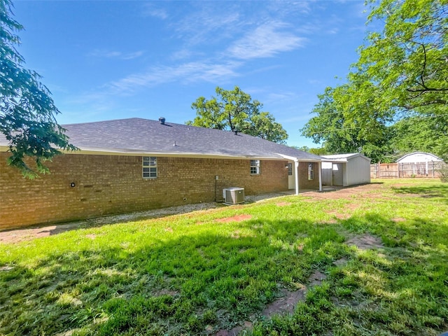 316 W 3rd Ter, Springtown, TX 76082 - back of property featuring fence, a lawn, brick siding, and central AC