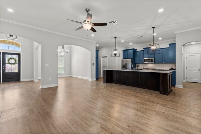 kitchen with recessed lighting, stainless steel appliances, visible vents, blue cabinetry, and open floor plan