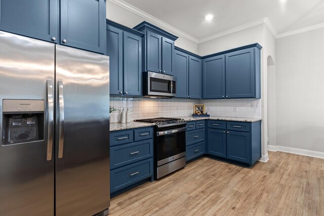 kitchen with blue cabinetry, light stone counters, light wood-style floors, baseboards, and appliances with stainless steel finishes