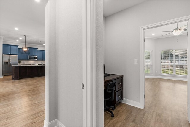 hall featuring light wood-type flooring, baseboards, and recessed lighting