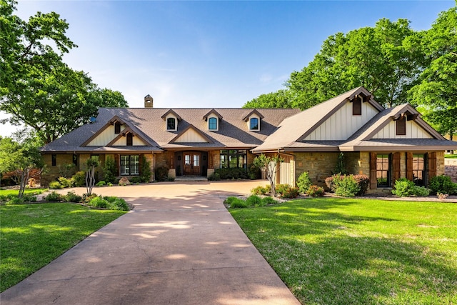 craftsman house featuring a chimney, a front lawn, stone siding, board and batten siding, and curved driveway