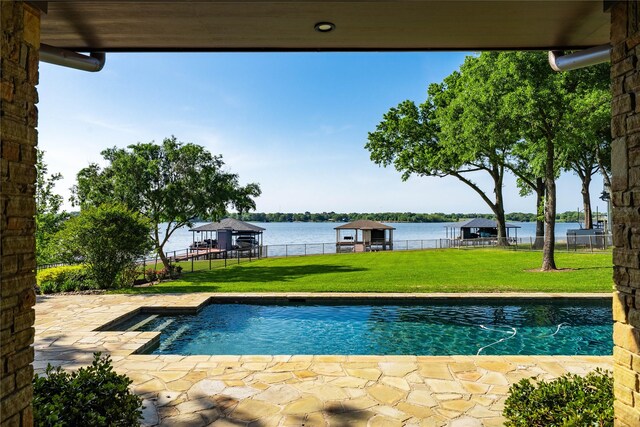 view of swimming pool with a yard, a fenced in pool, a water view, and fence