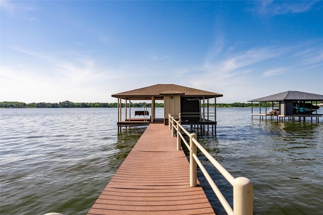 dock area with boat lift and a water view