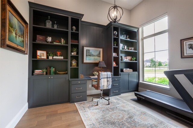office with an inviting chandelier, baseboards, and light wood-style flooring