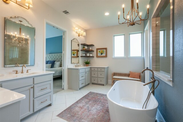 ensuite bathroom featuring visible vents, tile patterned flooring, two vanities, a sink, and an inviting chandelier
