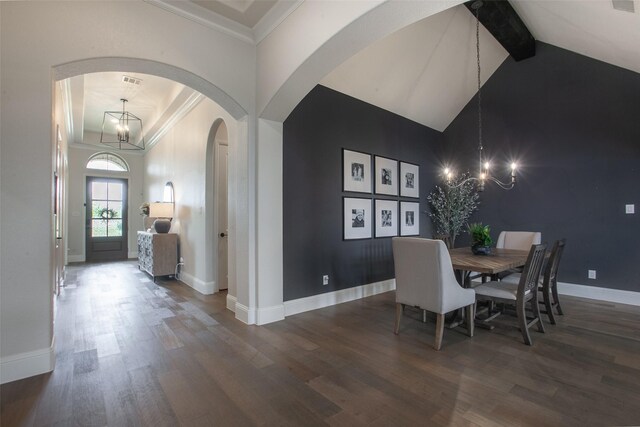 dining space with arched walkways, baseboards, a notable chandelier, and wood finished floors