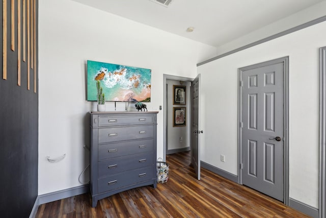 bedroom featuring visible vents, dark wood-style floors, and baseboards