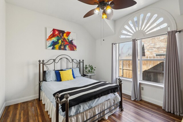 bedroom with lofted ceiling, baseboards, wood finished floors, and ceiling fan
