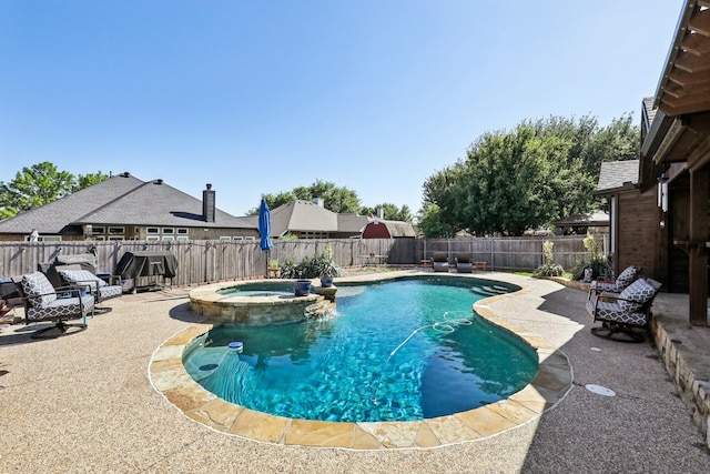 view of pool featuring a pool with connected hot tub, a fenced backyard, and a patio area