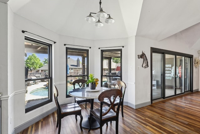dining area with wood finished floors, a healthy amount of sunlight, baseboards, and a notable chandelier