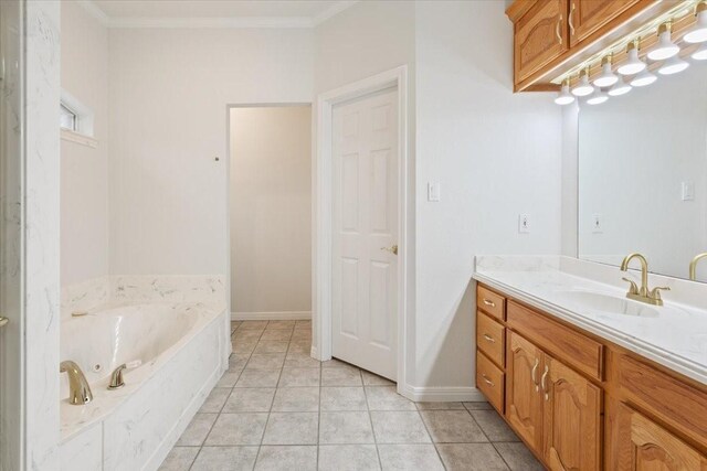 bathroom featuring tile patterned floors, a jetted tub, vanity, ornamental molding, and baseboards