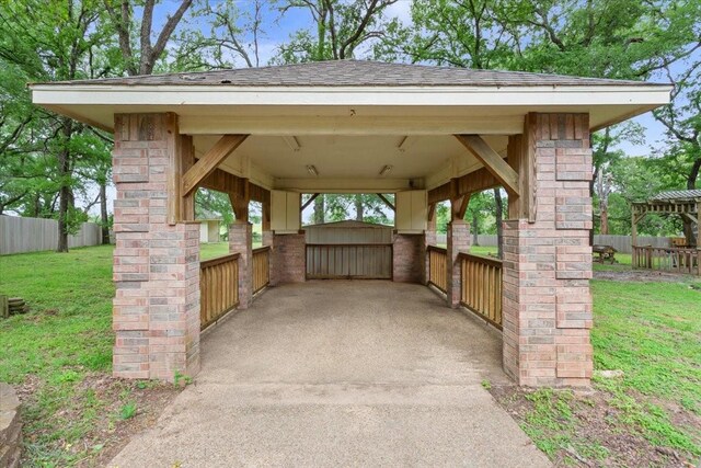 exterior space featuring fence and a carport