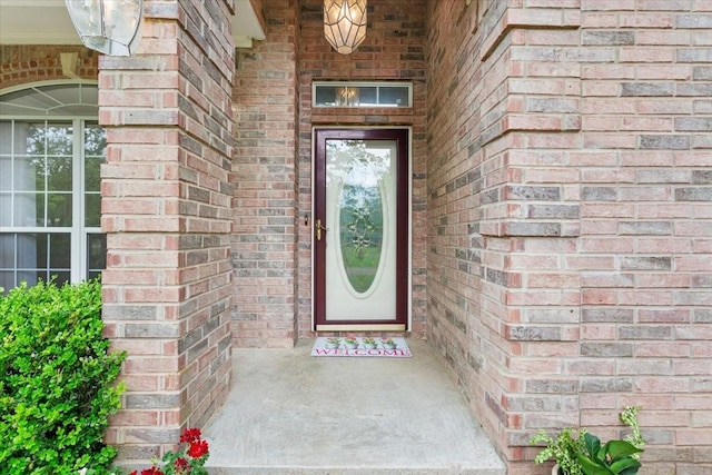 property entrance with brick siding