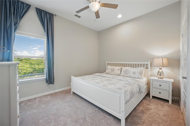 bedroom featuring baseboards, light carpet, recessed lighting, and visible vents