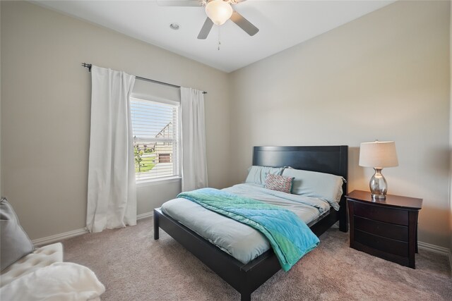 carpeted bedroom featuring baseboards and ceiling fan