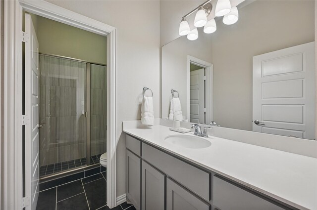 full bath with vanity, tile patterned flooring, toilet, and a shower stall
