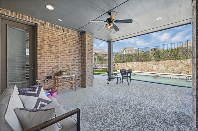 view of patio / terrace with ceiling fan, an outdoor pool, and fence