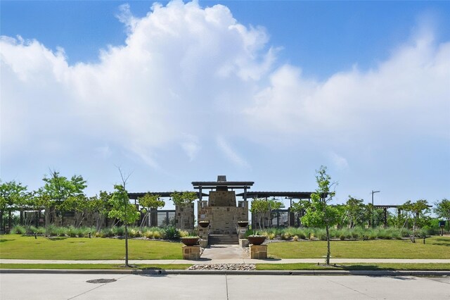 view of property's community with a lawn