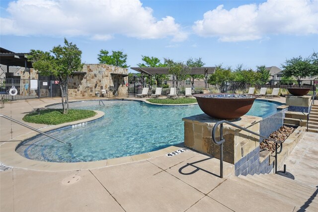 pool with a pergola, fence, and a patio area