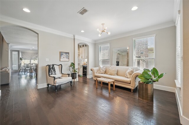 living area featuring visible vents, ornamental molding, wine cooler, baseboards, and arched walkways