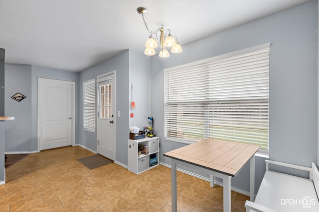entrance foyer with baseboards, an inviting chandelier, and a healthy amount of sunlight