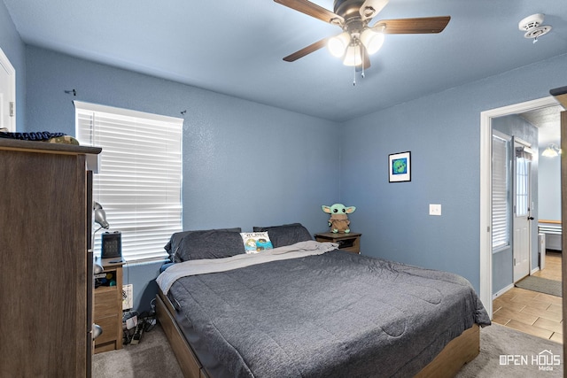 bedroom featuring baseboards, a ceiling fan, and tile patterned floors