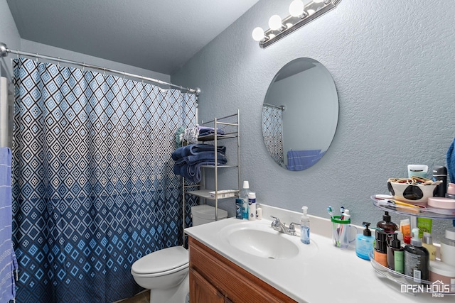 full bath with a textured wall, toilet, vanity, and a shower with curtain