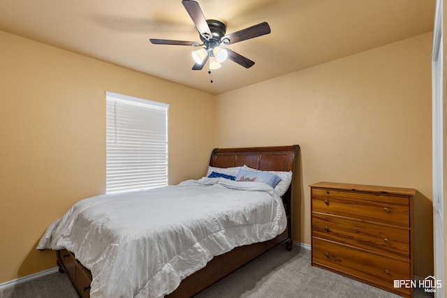 carpeted bedroom featuring baseboards and a ceiling fan