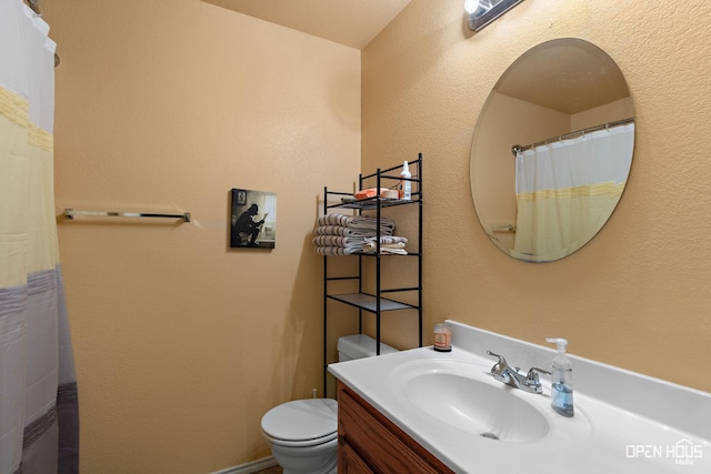 bathroom with toilet and vanity
