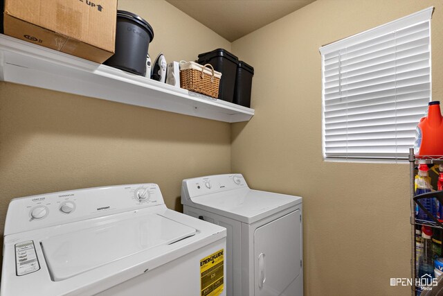laundry room with washing machine and clothes dryer and laundry area