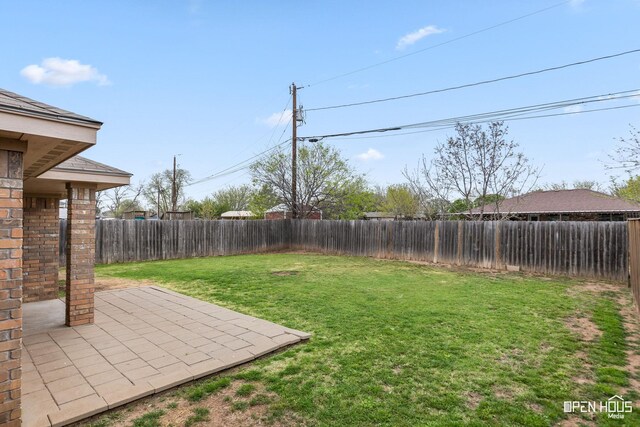 view of yard with a fenced backyard and a patio