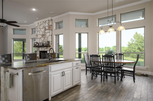 8636 Morgan Rd, Blue Ridge, TX 75424 - kitchen with stainless steel dishwasher, a sink, crown molding, a ceiling fan, and a stone fireplace