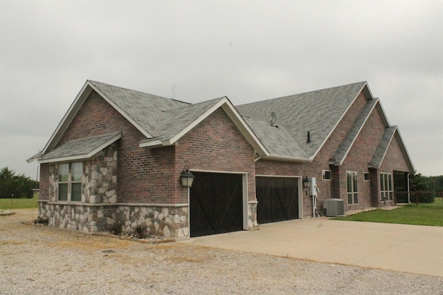 8636 Morgan Rd, Blue Ridge, TX 75424 - view of front of property with central air condition unit, an attached garage, a shingled roof, driveway, and stone siding