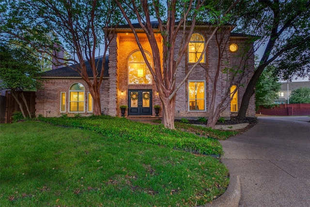7021 Castle Creek Ct, Fort Worth, TX 76132 - traditional-style home featuring brick siding, french doors, a front yard, and fence