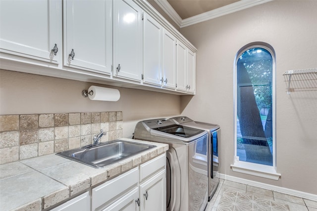 7021 Castle Creek Ct, Fort Worth, TX 76132 - laundry area featuring light tile patterned floors, a sink, crown molding, washer and dryer, and cabinet space
