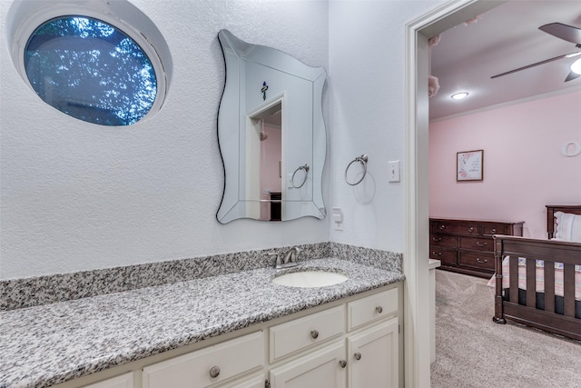 7021 Castle Creek Ct, Fort Worth, TX 76132 - bathroom with a textured wall, a ceiling fan, and vanity