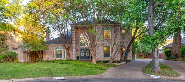 7021 Castle Creek Ct, Fort Worth, TX 76132 - traditional home featuring fence, a front lawn, french doors, and brick siding