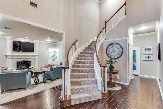 7021 Castle Creek Ct, Fort Worth, TX 76132 - foyer featuring dark wood finished floors, crown molding, a towering ceiling, and visible vents