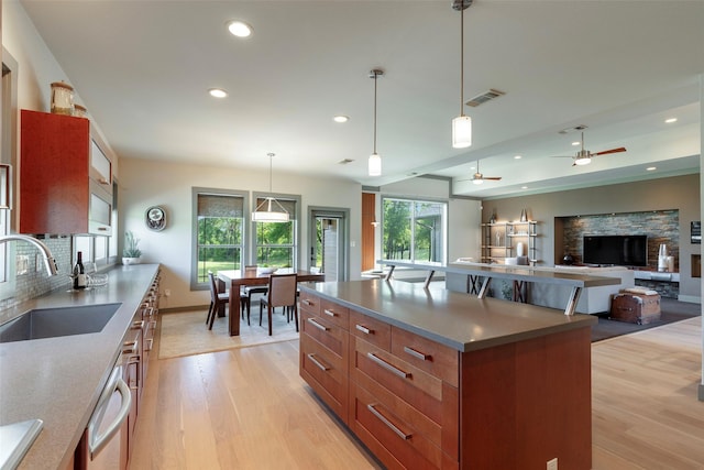 1228 Miller Rd, Melissa, TX 75454 - kitchen featuring a sink, light wood-type flooring, recessed lighting, brown cabinets, and dishwasher