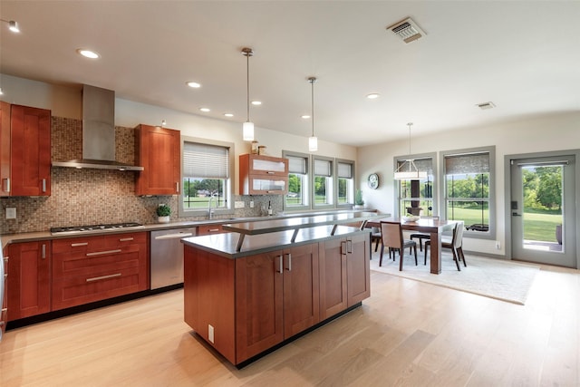 1228 Miller Rd, Melissa, TX 75454 - kitchen with backsplash, light wood finished floors, wall chimney exhaust hood, and appliances with stainless steel finishes