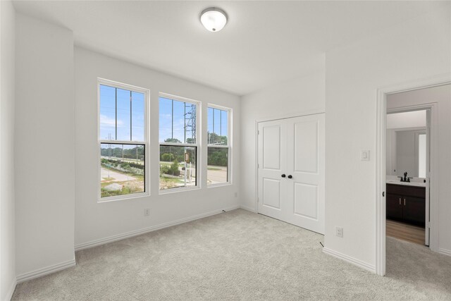 917 Janwood Dr, Plano, TX 75075 - unfurnished bedroom with carpet floors, a sink, baseboards, and a closet
