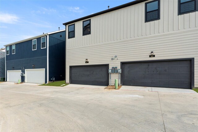 917 Janwood Dr, Plano, TX 75075 - view of side of home featuring a garage, concrete driveway, and board and batten siding