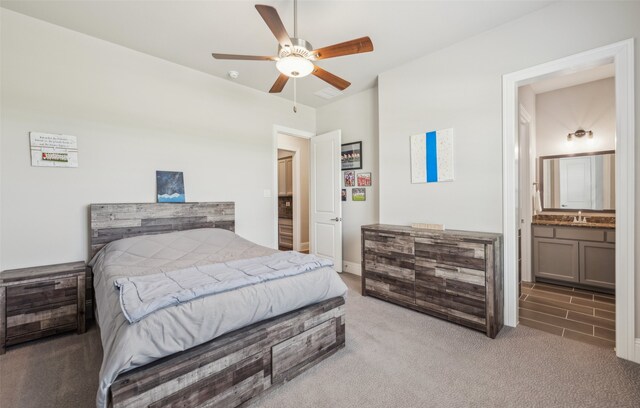 bedroom with a sink, visible vents, carpet, ceiling fan, and ensuite bath