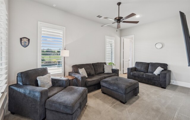 living area featuring recessed lighting, visible vents, a ceiling fan, baseboards, and light colored carpet
