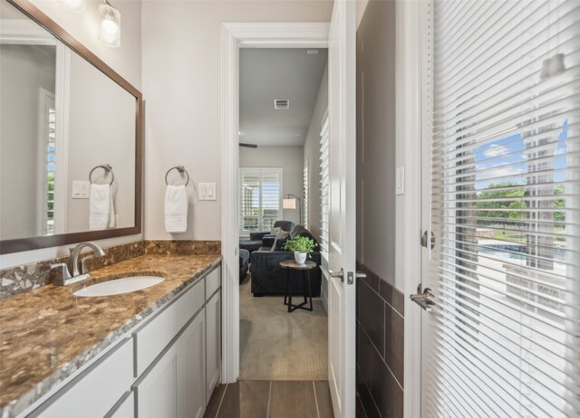 bathroom with ensuite bath, visible vents, tile patterned flooring, and vanity