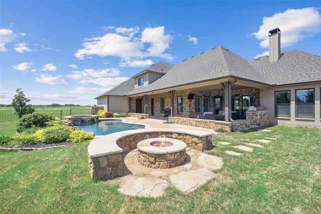 view of pool with a lawn, fence, a patio area, and an outdoor fire pit