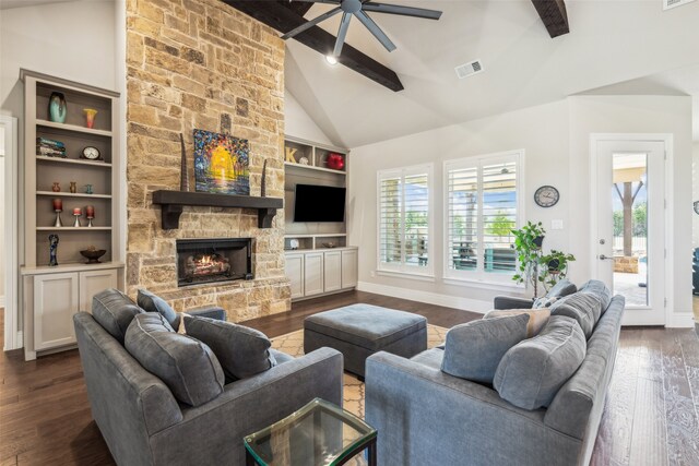 living room featuring visible vents, a ceiling fan, a wealth of natural light, and dark wood-style flooring