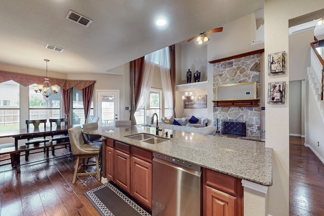 4001 Dellman Dr, Fort Worth, TX 76262 - kitchen with stainless steel dishwasher, a sink, visible vents, and a fireplace