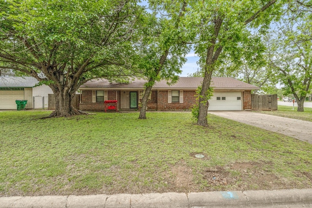 ranch-style home featuring a garage, driveway, fence, a front yard, and brick siding
